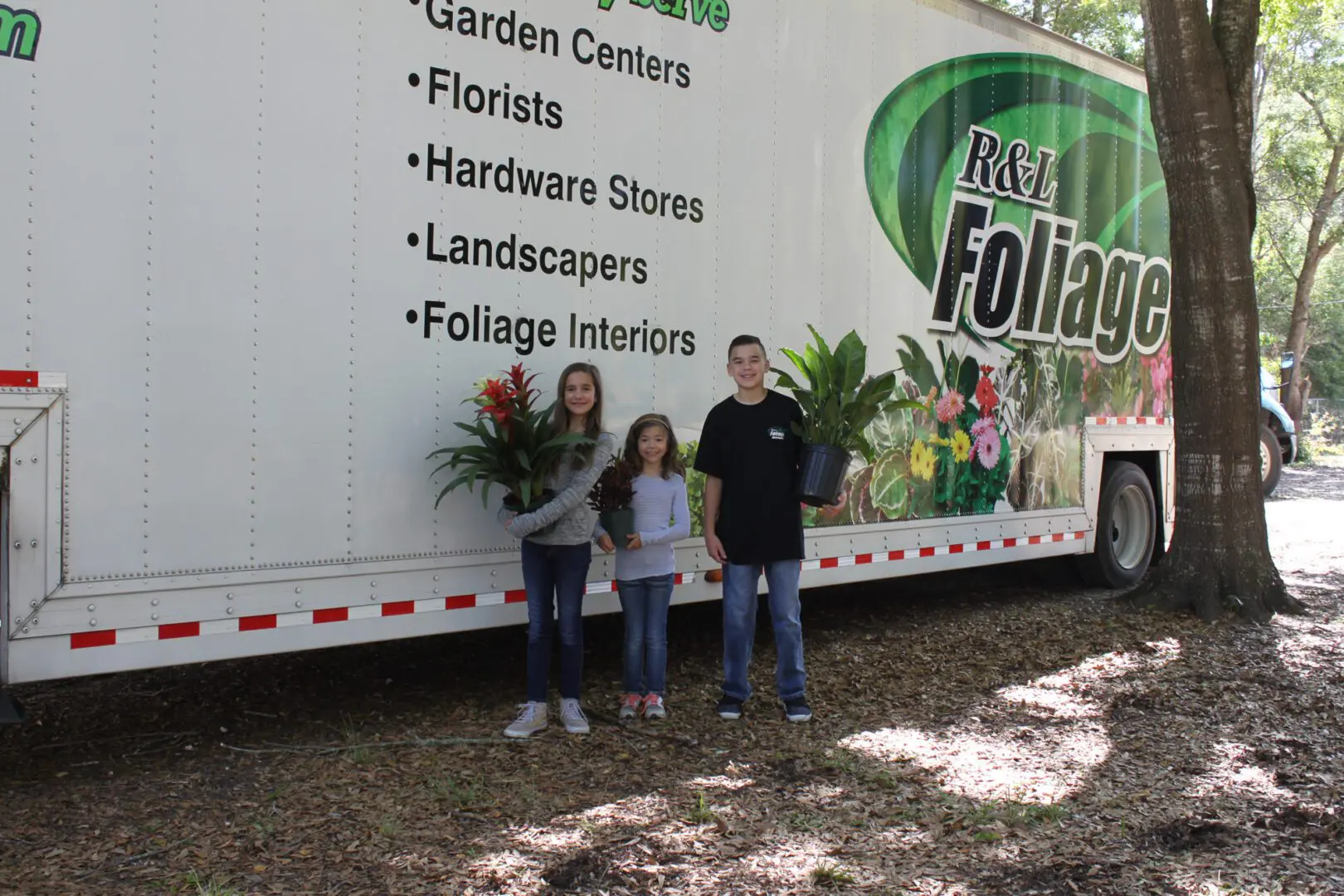 A couple of people standing in front of a truck.